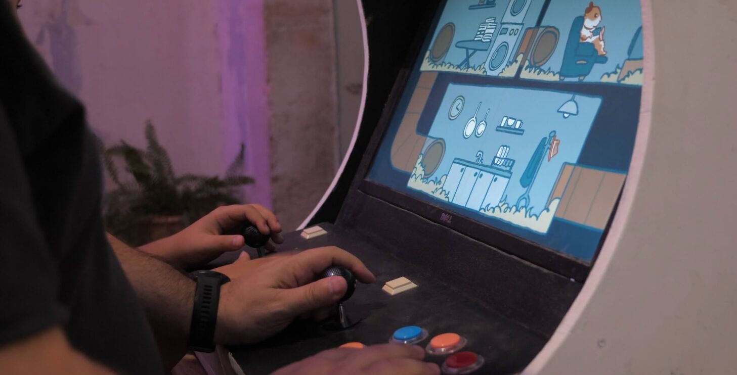 Hands on the arcade cabinet's joysticks