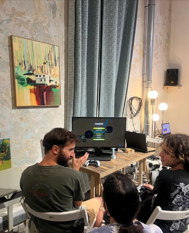Players pausing mid-game at A Pot To Carry