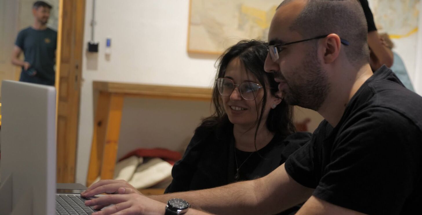 Two developers at a laptop